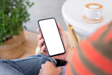 cell phone mockup blank white screen.man hand holding texting using mobile on desk at coffee shop.background empty space for advertise.work people contact marketing business,technology