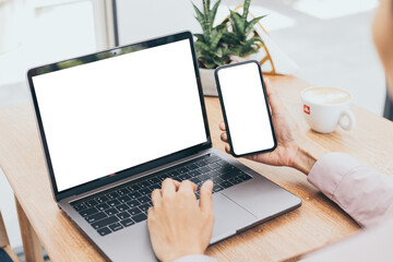 computer,cell phone mockup.hand woman work using laptop texting mobile.blank screen with white background for advertising,contact business search information on desk in cafe.marketing,design