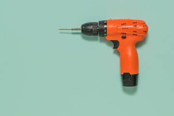 Orange screwdriver on a light blue background.