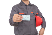 A Migrant Worker With A Red Safety Helmet In His Arm And A Train Ticket For Returning Home During The Spring Festival In The Other Hand