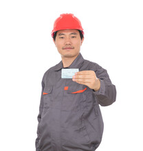 A Migrant Worker Wearing A Red Safety Helmet Holding A Train Ticket Home For The New Year