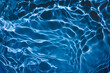 © Aleksandra Konoplya - De-focused transparent dark blue colored clear calm water surface texture with splashes and bubbles. Trendy abstract nature background. Water waves in sunlight with copy space.