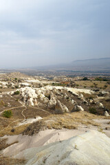 Wall Mural - Natural landscape of Cappadocia, semi-arid region in central Turkey known for its distinctive fairy chimneys, tall cone-shaped rock formations clustered in Monks Valley, Göreme and elsewhere- Kayseri