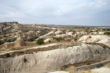 Wall Mural - Natural landscape of Cappadocia, semi-arid region in central Turkey known for its distinctive fairy chimneys, tall cone-shaped rock formations clustered in Monks Valley, Göreme and elsewhere- Kayseri