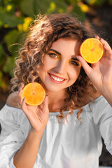 Sticker - Beautiful young woman with orange in sunflower field