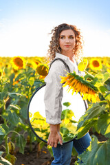 Sticker - Beautiful young woman with mirror in sunflower field