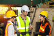 © JuYochi - Factory worker is standing and discussing each other.