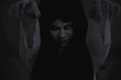 © sorapop - Horror woman ghost creepy stand lift 2 hands on the house, halloween day concept