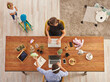 © UnitedPhotoStudio - Working from home family style with baby, wooden table, laptop lamp and toy decor.