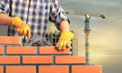 Wall Mural - Bricklayer worker installing brick masonry