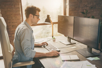 Profile side photo of focused concentrated guy sit desk work home computer solve software cyber space java script error look screen in workstation