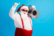 © deagreez - Photo of cool hispter santa claus with beard stomach listen x-mas christmas boom box wear red style stylish trendy suspenders overalls cap isolated over blue color background