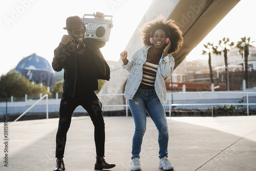 Cuadros en Lienzo African people dancing outdoor listening music from vintage boombox stereo - You