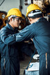 © totojang1977 - Team of Asian engineer mechanic man checking and using wrench for maintenance pressing metal machine at factory, worker at industrial working concept