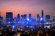 © VideoFlow - Glowing hologram of technological process, aerial panoramic cityscape of Bangkok at sunset. The largest innovative hub of tech services in Asia. Multi exposure.