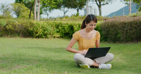 Sticker - Woman work on laptop computer and sit on green lawn