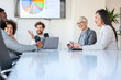 © Sanja - A group of business partners sit in a conference room and agree on new business details
