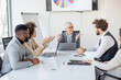 © Sanja - A group of business partners sit in a conference room and analyze the business of their corporation, the boss talking about new business