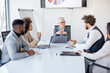 © Sanja - A group of business partners sit in a conference room and analyze the business and profits of their corporations