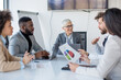© Sanja - A group of business partners sit in a conference room, employees suggest new ideas in making a profit