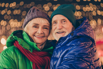 Wall Mural - Adorable affectionate bonding two married people old woman man enjoy x-mas christmas jolly holly eve evening atmosphere walk under lights outdoors wear season coat headwear scarf