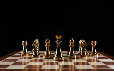 Golden chess figures standing on chessboard