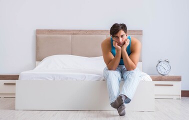 Wall Mural - Young man waking up in bed