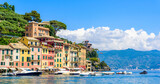 Fototapeta  - Portofino, Italy - Harbor town with colorful houses and yacht in little bay. Liguria, Genoa province, Italy. Italian fishing village with beautiful sea coast landscape in summer season.