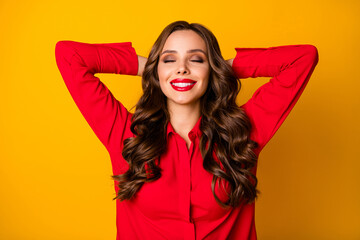 Poster - Photo of attractive funny curly lady hold hands behind head eyes closed break relaxing meditating enjoy formalwear red office shirt isolated bright yellow color background