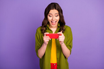 Sticker - Portrait of her she nice attractive lovely addicted cheerful cheery wavy-haired girl using device playing game pastime isolated on bright vivid shine vibrant lilac violet purple color background