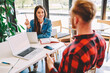© BullRun - Happy male and female freelancers sitting at table desk with mockup technology with copy space area for your internet advertising, Caucasian students discussing university exams and e learning