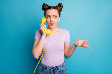 Sticker - Photo of pretty lady two funny buns hold cable telephone handset speaking chatting friends explaining last gossips rumors wear casual purple t-shirt isolated blue color background