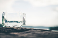 Close-up Of Glass On Table Against Sky