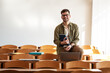 © BalanceFormCreative - Portrait of a young male university student taking a test in a classroom. Educational concept.