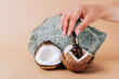 Coconut and a tube of cosmetics on a stone background