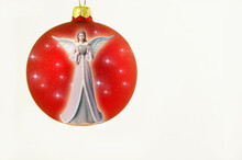 Red Christmas Ball Decoration With Stars And Angel Wuth Heart Like Merry Christmas Angel Greeting  Over White Background 