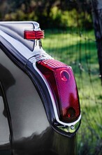 Vertical: Close Up Classic, Vintage Car Tail Light And Chrome Fin Fender