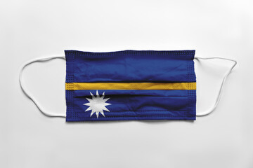 Wall Mural - Face mask with Nauru flag printed, on white background, isolated