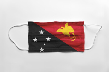 Canvas Print - Face mask with Papua New Guinea flag printed, on white background, isolated