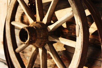 Wall Mural - Wooden brown cart wheel close up view 