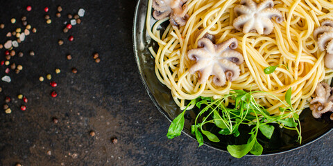 spaghetti pasta baby octopus seafood warm salsd fresh second course on the table tasty serving size top view copy space for text food background rustic