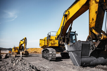 Wall Mural - Excavator work loading of coal into Yellow mining truck. Open pit mine industry