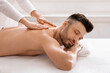 © Prostock-studio - Side view of relaxed man having body massage at spa