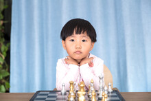 Little Chinese Girl Learning Chess