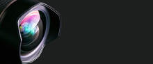 .Camera Lens On A Black Background. Wide-angle Close-up Lens. Macro. Banner.