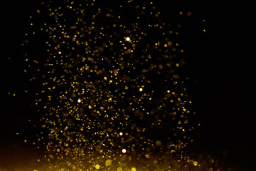 Sticker - Sparkling golden glittering effect isolated on black background.