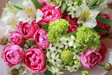 Fototapeta Tulipany - Pink-green bouquet of roses, white lilies, hydrangeas close up