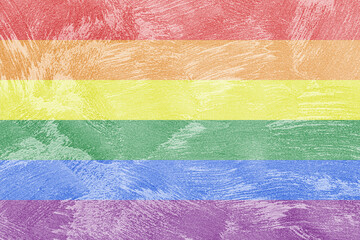 Rainbow LGBTQ or gay pride flag on decorative plaster or concrete texture. Abstract background.