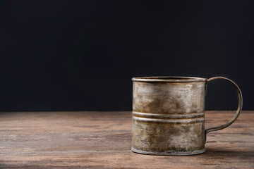 Wall Mural - retro metal coffee mug above the old wooden table