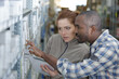 © auremar - female hardware store seller with client